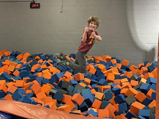 My son jumping into the foam pit.