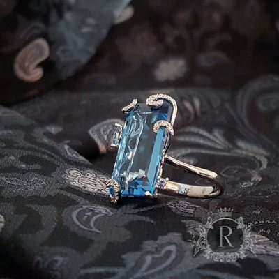 Custom One of a Kind. Elongated Blue Topaz with diamonds on the Floral Prongs and Basket