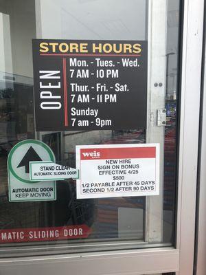 Store hours, and hiring information on the door