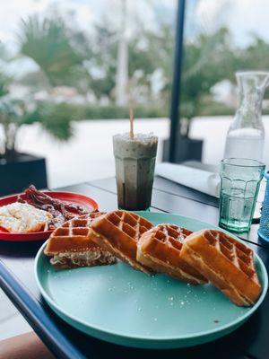 Egg and bacon waffle with bacon and eggs on the side