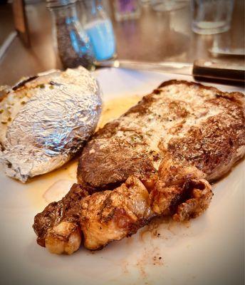 Ribeye steak with a side of baked potato