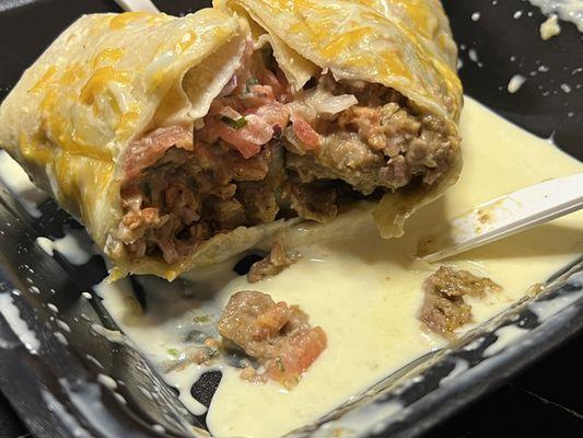 Build Your Own Burrito cut with chicken, sour cream, 'green chile' and pico. Cheese on top.