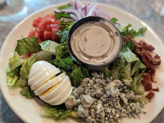 Half Cobb salad with blue cheese dressing.