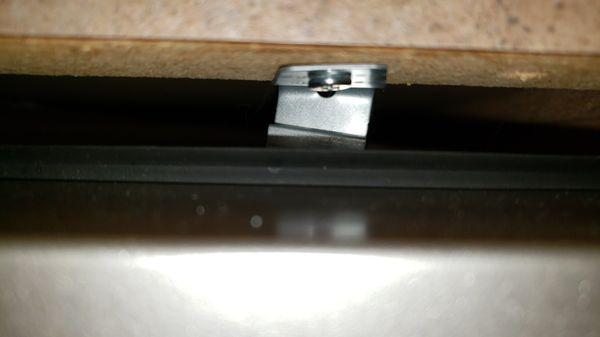 Bent mounting plate on dishwasher