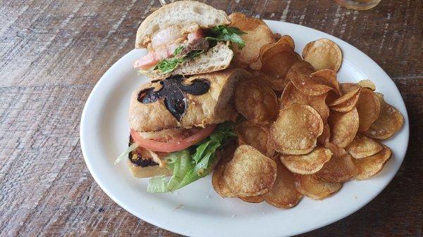 Shrimp po boy with chips.