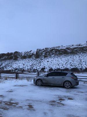 Muddy, tinted car in the middle of Wyoming