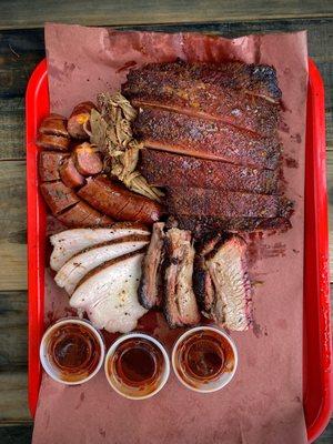 Platter w/ Smoked turkey breast, marbled brisket, jalapeño cheddar sausage, pulled pork and ribs.