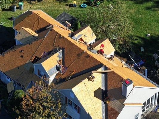 Saratoga roofing crew working hard on a very steep roof.