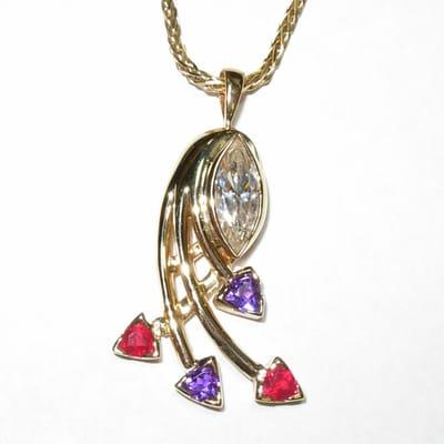 Semi-custom mother's pendant with amethysts, rubies, and customer's marquise diamond