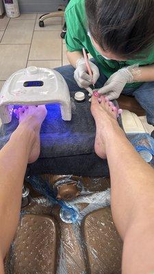 Deluxe spa pedicure with hand painted polish detail design