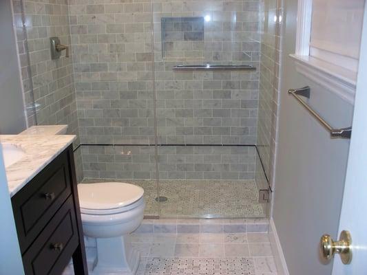 New tile in bathroom, floor, 3 sides, new fixtures, and toilet.