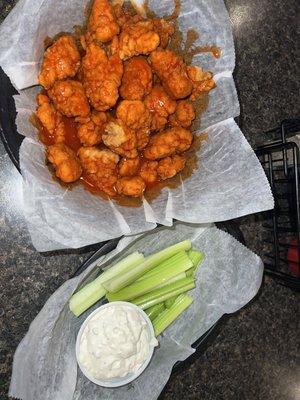 Boneless hot buffalo flavored chicken wings (breaded pieces of chicken) with celery and bleu cheese dressing.