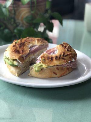 Cheesy garlic bagel with egg, ham, cream cheese and avocado!