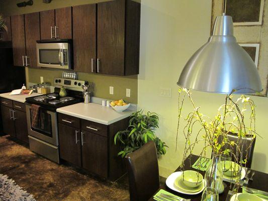 Modern kitchens with dark cabinetry and stainless steel appliances at the Barcelona Lofts