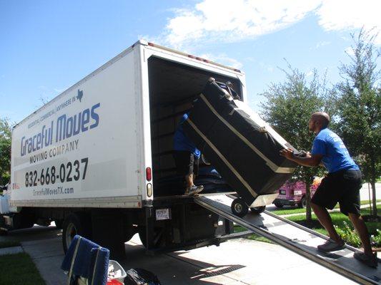 Safely moving you furniture into the trucks.