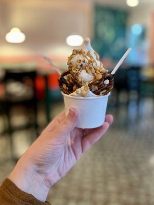 Peanut butter and marshmallow swirl with peanut butter sauce, peanuts, and a chocolate-covered pretzel