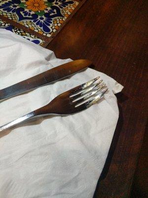 Dirty silverware, all crusted to the fork