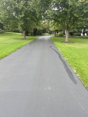 Patch work on a new driveway where their sealcoating cracked