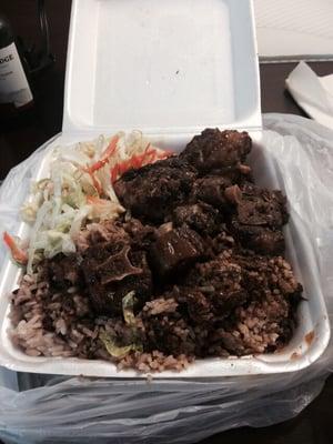 Large oxtail with beans and rice and a salad.