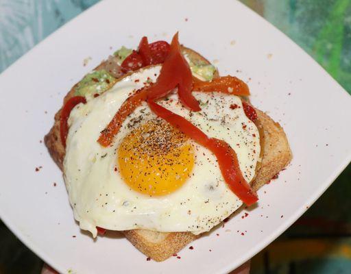 Avocado smashed toast with a sunny side up egg and feta !