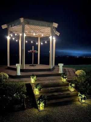 Gazebo lit up at night. We rented a custom made cross and lanterns.