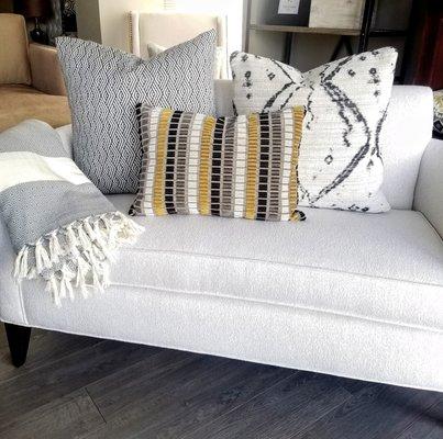 In stock custom made pillows: Global modern pillows in black and white textured prints with pops of gold/black/white cut velvet patterns