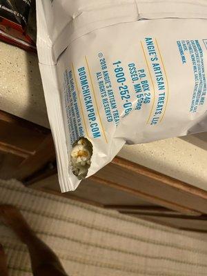 A hole the mice made in a bag of popcorn