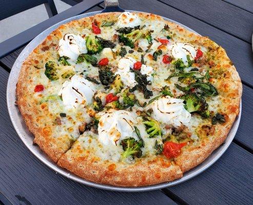 Penny Lane  pesto, crumbled sausage, broccoli, sweet drop peppers, mozzarella, feta, ricotta, basil