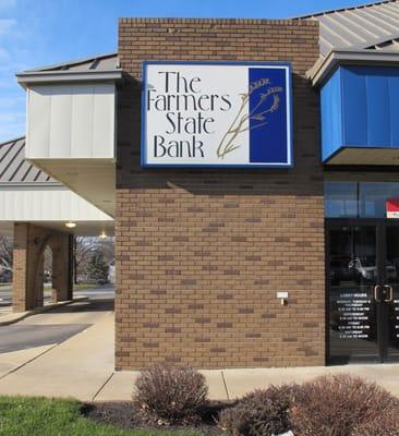 Sign on the front of The Farmers State Bank at the corner of SR 43 and 4th St.