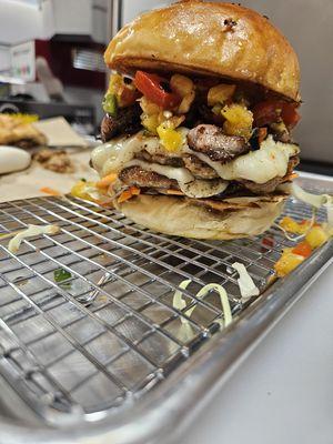 Jive Jerk Burger. Smashed patties with pepper jack cheese jerk bacon with pineapples red pepper and jalapenos.