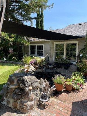 Shade sail over koi pond