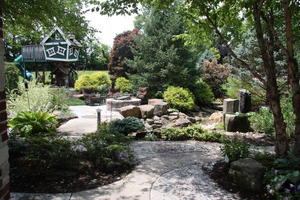 Custom Treehouse, Firepit , Basalt Water Feature, Colorful Plantings and Custom Concrete Patio