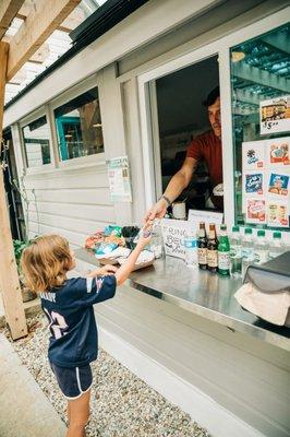 Our Oasis snack bar serves grilled hot dogs/sausage, kettle corn, ice cream, fresh lemonade, baked treats, and more!