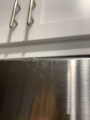 Permanent scratches and scuffs on top of the fridge.