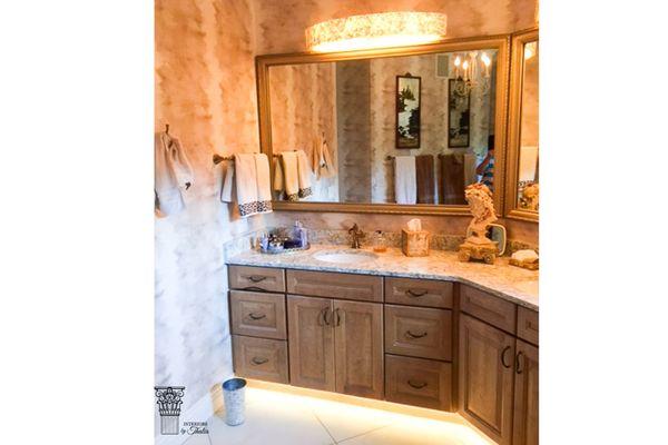 A romantic bathroom uses mother of pearl vanity lights, a mother of pearl accent tile with a pearlized wallpaper to accentuate beauty.