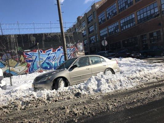 Manny dislodging my car from a snowpit.