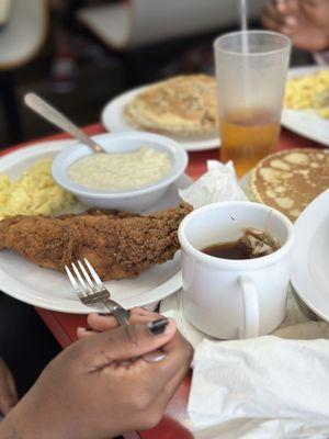 Fish, grits, eggs, tea, pancakes