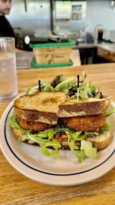 Fried Green tomato sandwich with a side of salad