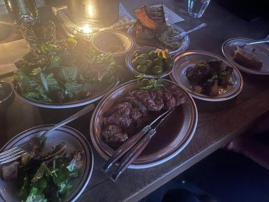 Counter clockwise: rosette plate, herb salad, steak, Japanese sweet potatoes, marinated olive in center