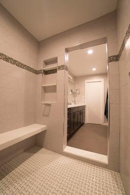 Inside the double shower looking out in to the master bathroom.  Complete with custom niche, custom 'floating' bench and chrome accents