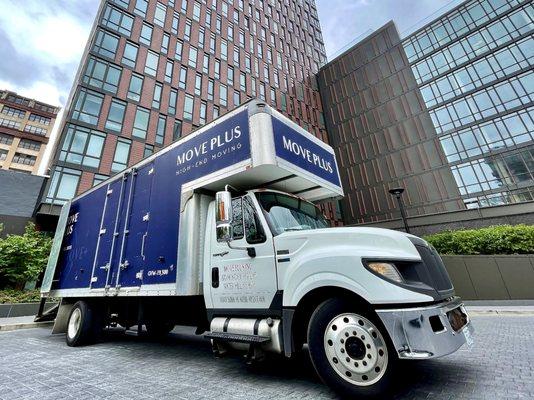 Move Plus truck unloading at a luxury NYC residential building.