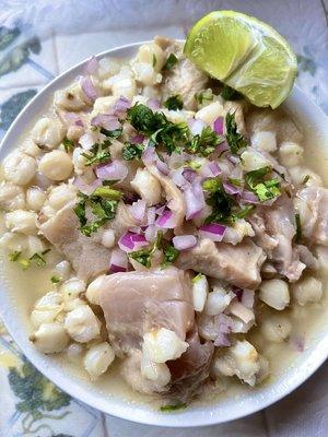 Our delicious white menudo with freshly cut purple onions, cilantro and lime