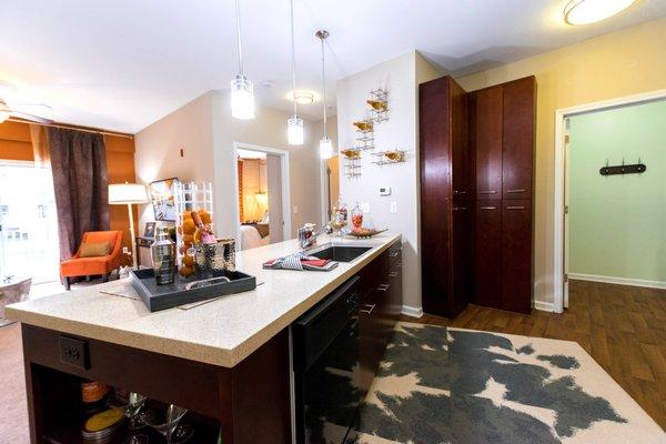 Kitchen with granite countertops, designer lighting, dark cabinetry, and black appliances