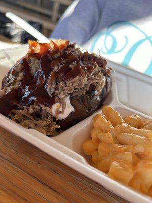 Smoked tater topped with pulled pork with side of smoked Mac and cheese