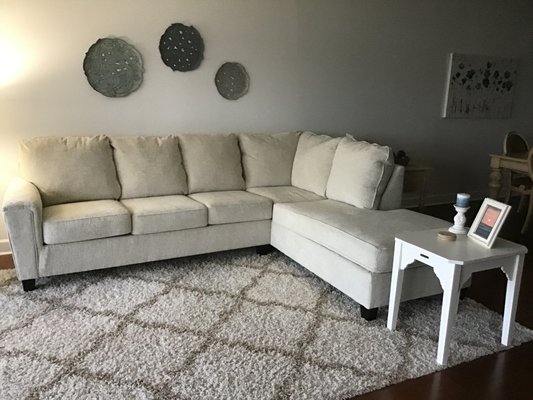 Linen sectional with chaise. Very comfortable and has a coastal elegance feel to it.