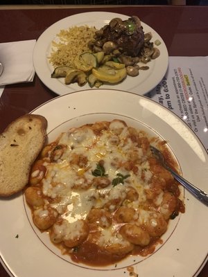 Top:  filet mignon topped with sautéd mushrooms, rice pilaf and veggies. Bottom:  gnocchi with marinara sauce and mozzarella cheese..