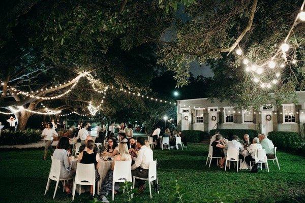 Outdoor corridor for guests to enjoy a dinner underneath the oaks during a reception or a place to party.