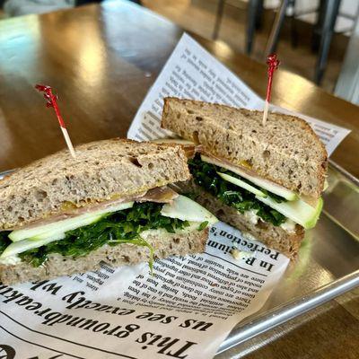 Apple, Brie & Prosciutto. Olive oil,basil & prosciutto di parma,brie,green apples,arugula,honey mustard on multigrain bread.