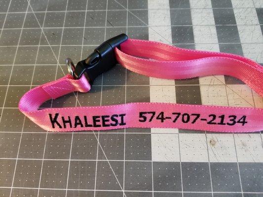 Dog collar embroidered with dogs name and contact phone.