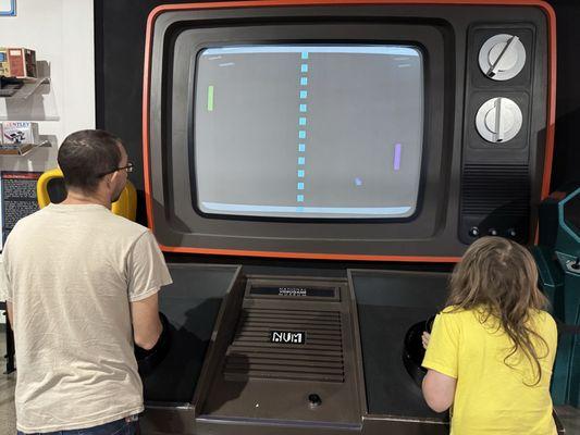 A giant screen in which to play the video game Pong at the National Video Game Museum.